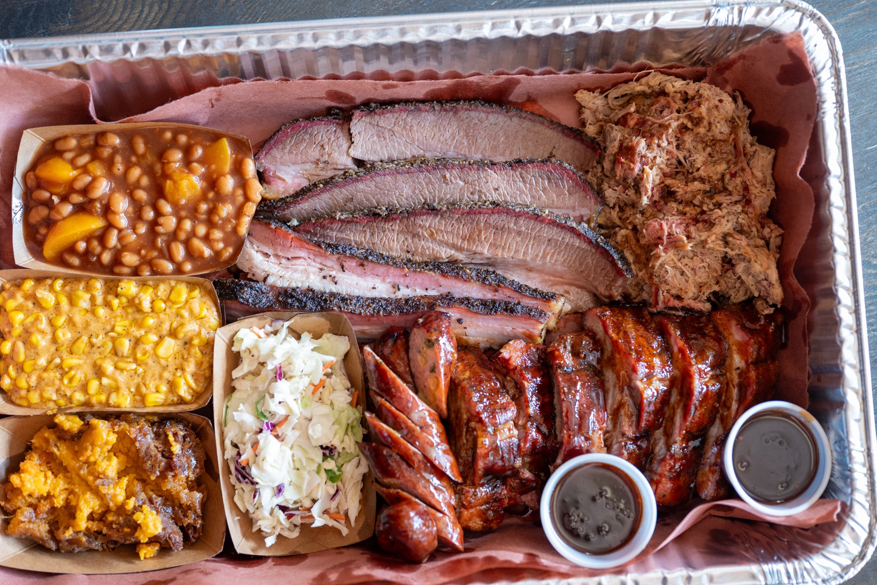 Smoked brisket, pulled pork, ribs, and sausage platter at Southern Q